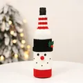Close-up of a knitted snowman wine bottle cover with festive red and white details - Snowman Style