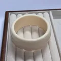 Minimalist wide geometric resin bangle in creamy white finish on jewelry box display - Solid White