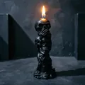 Detailed view of black triple skull candle with non-see hear speak design for Halloween - Black