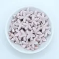 Close-up of glossy lavender starfish ceramic beads for DIY jewelry and crafts - Dusty Pink