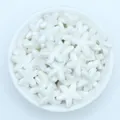 Macro shot of white glazed starfish ceramic beads for DIY jewelry making - White