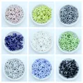 Starfish ceramic beads in nine colors for DIY jewelry making displayed in white bowls - Multicolor