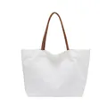 Minimalist white canvas tote bag featuring brown leather-style handles for daily commute - White