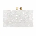 Macro view of white marble acrylic evening clutch with gold geometric metal clasp - White
