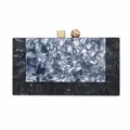 Detail of evening clutch featuring marble texture acrylic and golden geometric clasp - Black