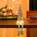 Detail of LED glowing Christmas gnome with sequin hat and striped hanging legs - Rose Gold Sequin Long Leg Style / Rose Gold