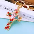 Golden cross keychain with multicolored crystals and a large pink teardrop gemstone - Pink Crystal Cross (A792)