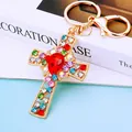 Golden cross keychain with colorful rhinestones and red pear-shaped center crystal - Red Crystal Cross (A792)