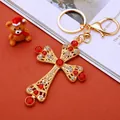 Golden cross keychain with red and white crystals on an orange background - Red Pearl Cross (A902)