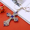 Silver cross keychain with blue and white crystals on a festive holiday background - Antique Silver Royal Blue Cross (902)