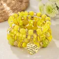 Detail of yellow multilayer beaded bracelet with heart pendant engraved with I Love You - Yellow