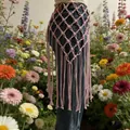 Pink bohemian hand-woven macrame waist belt with long tassels over denim jeans - Style 11