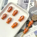 Detailed view of orange ceramic fish beads with glossy finish for DIY jewelry crafts - Orange