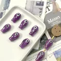 Detail of lavender purple ceramic fish beads for jewelry making displayed on a tray - Purple