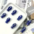 Detailed view of handmade dark blue fish-shaped ceramic beads with evil eye design - Royal Blue