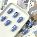 Close-up of blue fish-shaped ceramic beads with evil eye design for DIY jewelry - Light Blue