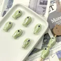 Pearlescent green fish-shaped ceramic beads for DIY jewelry making in a tray display - Light Water Green