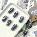 Macro detail of fish-shaped ceramic beads with pearl finish for DIY jewelry - Gray
