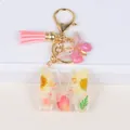 Floral resin letter M keychain with real dried flowers, butterfly charm and pink tassel - Letter M
