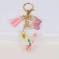 Detailed view of floral resin letter Y keychain with pink tassel and gold butterfly charm - Letter Y