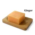 Handmade ginger soap with translucent orange texture on a natural wooden dish - Ginger (Plain Soap)