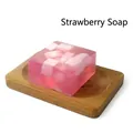 Pink translucent strawberry soap bar with embedded cubes on a wooden soap dish holder - Strawberry (Plain Soap)