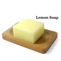 Translucent yellow lemon handmade soap bar on a wooden draining dish with lemon scent - Lemon (Plain Soap)