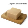 Natural handmade angelica soap bar in beige color on a wooden bamboo drainage tray - Angelica Soap