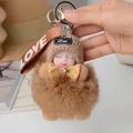 Sleeping baby doll keychain with brown plush fur ball and knitted hat on a metal ring - Plush Doll