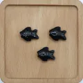 Drei schwarze Fisch-Keramikperlen auf Holztablett für DIY-Schmuckherstellung - Schwarz