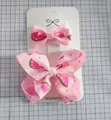 Pink handmade hair clips set with watermelon and floral patterns on ribbon bows - Watermelon Print