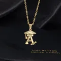 Detail of 2026 graduation necklace with crystal cap, custom name A, and gold scroll charm - Letter N