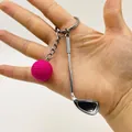 Zinc alloy golf club keychain with rose pink ball pendant held by a hand - Rose Red