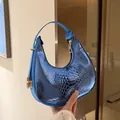 Metallic blue crescent bag with crocodile pattern and golden hardware, sleek minimalist style - Blue