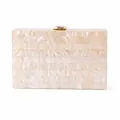 Detail of elegant ivory pearlescent acrylic evening clutch with gold metal clasp - Apricot