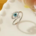 Silver evil eye ring with blue zircon inlay on white ceramic tray for women - Letter J