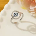 Adjustable evil eye ring with blue zircon inlay on white ceramic plate with floral decor - Letter T