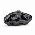 Macro detail of high-gloss black acrylic evening clutch with gold metal cylinder clasp - Black