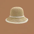 Detail of woven straw sun hat with elegant faux pearl embellishments and white trim - M (56-58cm)
