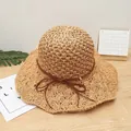 Natural straw sun hat with wide wavy brim and dark brown ribbon on wooden background - M (56-58cm) / Knitted Bow - Khaki