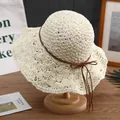 Cream wide-brim straw sun hat with brown bow tie on a wooden display stand - M (56-58cm) / Cream White with Bow