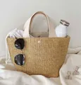 Detailed interior of woven straw tote bag showing compartments and summer vacation items - Off-white Handle Style / Off White