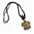 Detail of tribal turtle pendant with carved totems on black cord with wood beads - Brown
