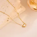 Detail shot of heart-shaped white shell pendant on a gold titanium steel necklace - XL8222J Mother of Pearl Heart Necklace Gold