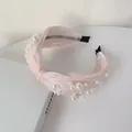 Pink satin headband with white pearl embellishments and a classic twisted knot design - Pearl Rhinestone Knotted Pink