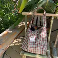 Vintage red and blue plaid canvas tote bag with 'SEE YOU' patch on a bamboo chair - A Tote Bag - Brown And Green Plaid