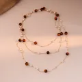 Detail of layered gold necklace with brown tiger eye beads and white pearls - 1# Necklace-Gold-Brown