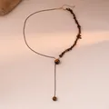 Detail of asymmetrical tiger eye beaded necklace with black cord and gold clasp - 3# Necklace-Coffee