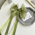 Elegant olive green organza bow hair clip for girls featuring long ribbons and faux pearls - Pearl Ribbon Bow / Green