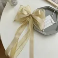 Elegant champagne ribbon hair bow with organza streamers and pearl pendants for girls - Pearl Ribbon Bow / Beige